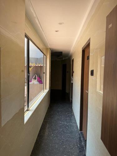 an empty hallway with a window in a building at Sangeetha Business Hotel in Chennai