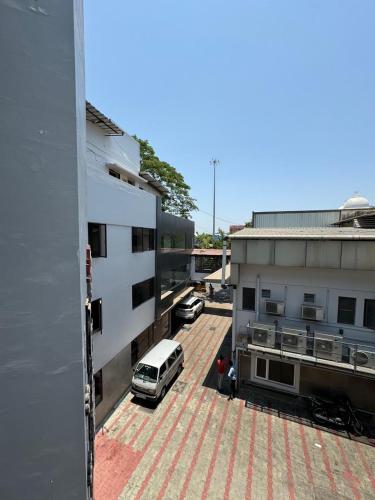 a car parked in a parking lot next to a building at Sangeetha Business Hotel in Chennai