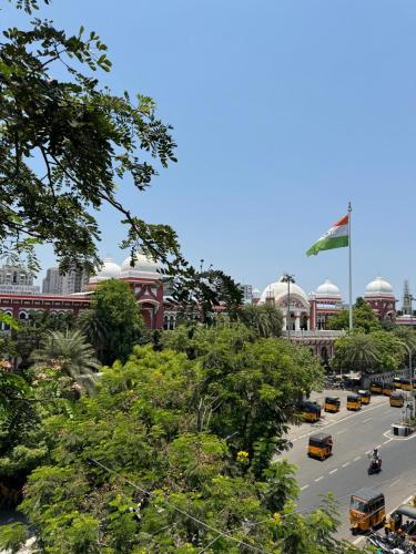 a view of a city street with buses and a flag at Sangeetha Business Hotel in Chennai