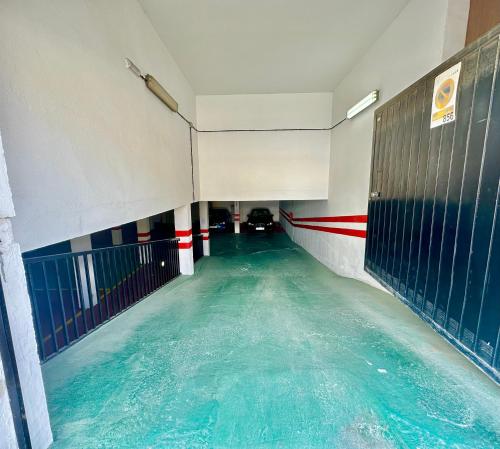 an indoor swimming pool with blue water in a building at Refugio Costero Tu Hogar vistas al Mar con Parking in Calahonda