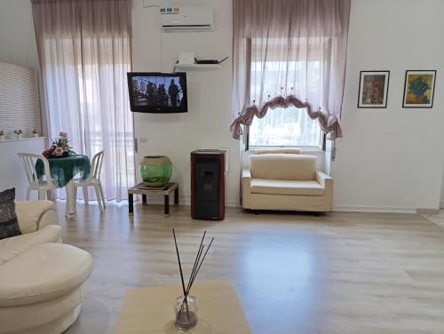a living room with a couch and a chair at Casa con ampio giardino e patio in Acerra