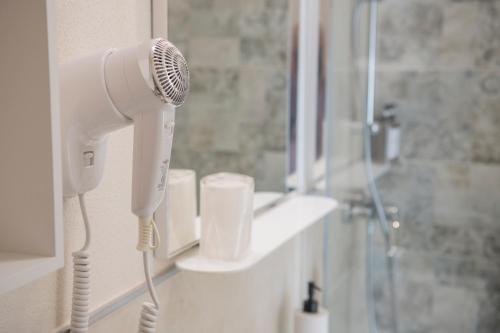 a bathroom with a blow dryer and a shower at B&B Al Parco in Verona
