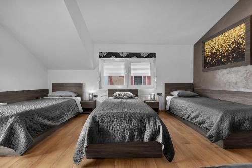 a bedroom with two beds and a window at Dormir Apartments in Zagreb