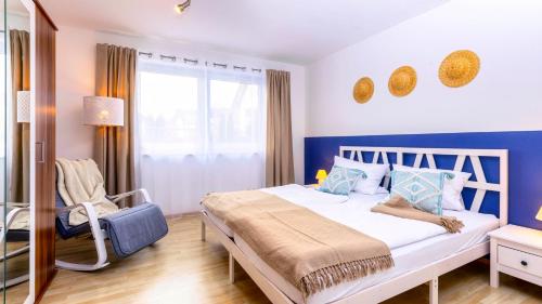 una camera con un letto bianco e una parete blu di Moderne Fewo mit Fasssauna und Kamin im ländl. Allgäu a Eggenthal