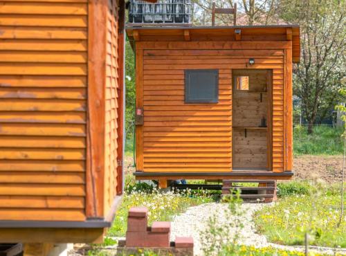 a wooden cabin with a door in a yard at Robinzonski Kamp Hofman in Varaždin