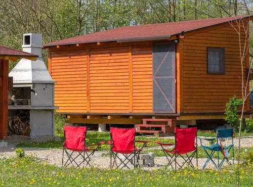 a group of chairs in front of a cabin at Robinzonski Kamp Hofman in Varaždin