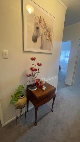 a room with a table with a deer head on the wall at Natthakan Heights in Te Kuiti