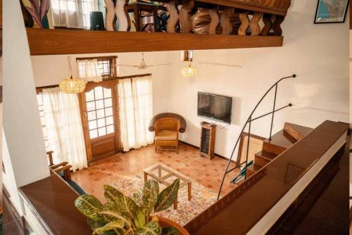 an aerial view of a living room with a staircase at Baywatch by GRHA - A Picturesque Beach Villa in Kozhikode