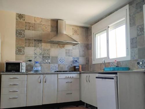 A kitchen or kitchenette at Clauhomes Nido del Golf