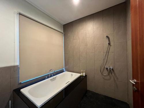 a bathroom with a tub and a shower at Villa Ophelia at Vimala Hills in Bogor