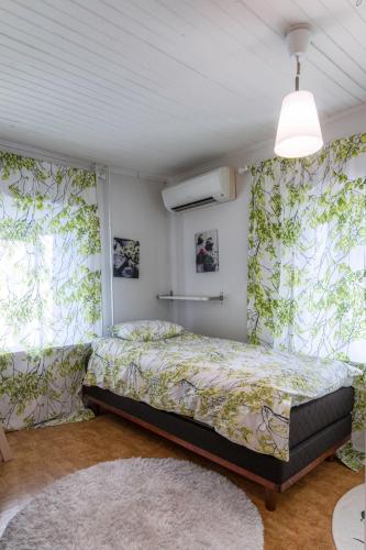 a bedroom with a bed and two windows at Relax & Recharge - a Unique Suite with a Touch of Luxury - Hot Tub and Sauna Inspired Decor #NOT A REAL SAUNA# Easy City Access - direct train 15 min to city in Helsinki