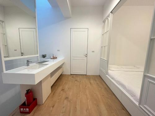 a bathroom with a sink and a mirror and a tub at 隨緣居民宿 in Zhongpu