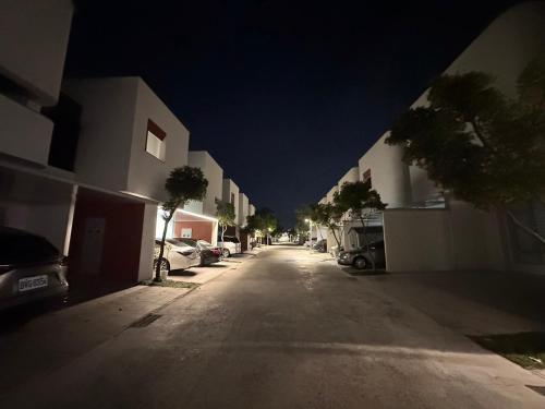 an empty street at night with cars parked at 隨緣居民宿 in Zhongpu