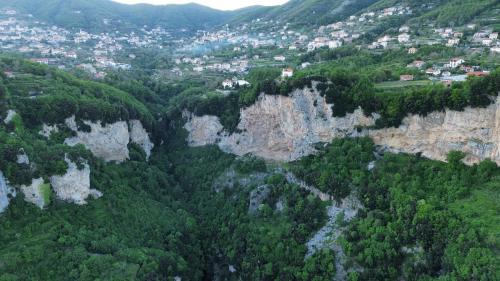 an aerial view of a mountain valley with trees and buildings at Agriturismo Orrido di Pino in Agerola