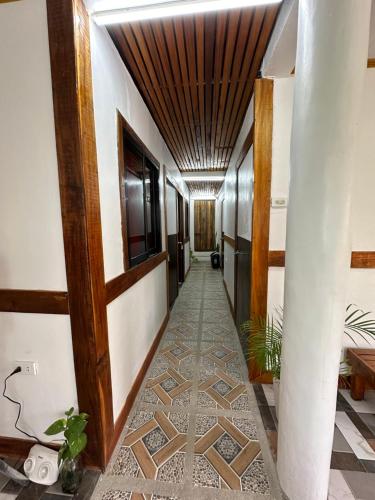 a hallway with a tile floor and a ceiling at Bearbys Homestay Siargao - C in Catangnan