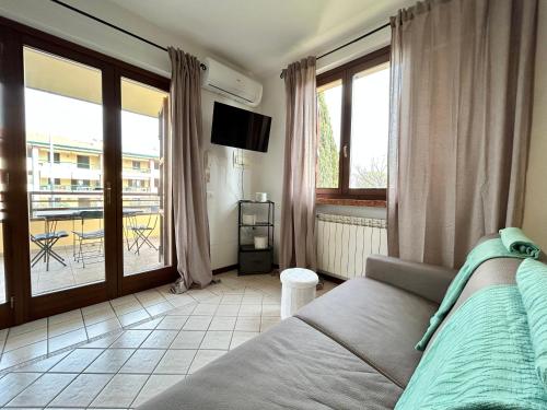 a bedroom with a bed and a view of a balcony at CASA JOSKA in Sirmione