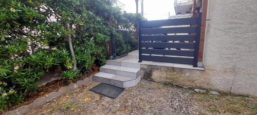 a set of stairs leading up to a door at STUDIO REFAIT A NEUF - 150m DE LA PLAGE in Marseillan