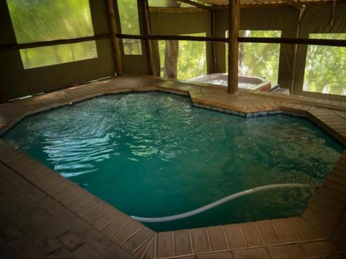 a large pool of water in a house at Riverview Spa Bed and Breakfast in Lanseria