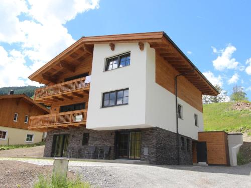 a house in the mountains with a balcony at Modern chalet with sauna near ski area in Saalbach Hinterglemm Salzburgerland in Saalbach Hinterglemm