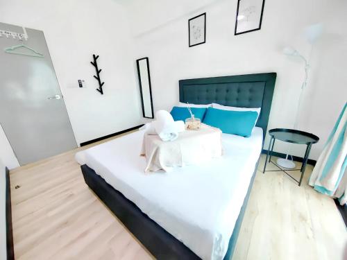 a bedroom with a large white bed with a chair at Meritus Residensi Penang in Perai