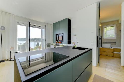 a kitchen with a sink and a counter top at Blue Breeze Apartment in Salò