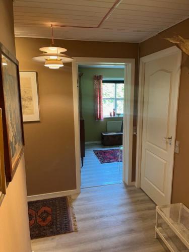 a hallway with a door leading to a living room at Bøllingsø Bed and Breakfast in Engesvang