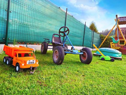 a toy truck with large wheels sitting in the grass at Chata u pltníka Paľka in Podbiel