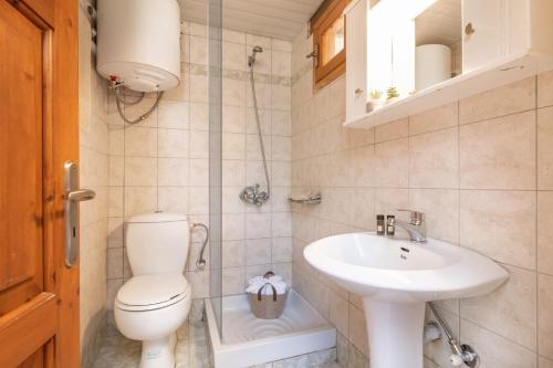 a bathroom with a toilet and a sink at Villa Sea Stone by Villa Plus in Makris Gialos
