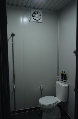 ein Badezimmer mit einem WC und einer Uhr an der Wand in der Unterkunft The Vanilla Cabin 