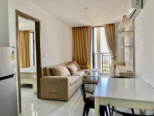 a living room with a couch and a table at The Vincent Condo in Phnom Penh