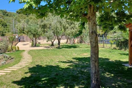 a park with a tree and a path at Berry House Nikiti in Skála Nikíta