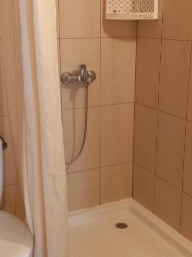 a bathroom with a shower with a shower curtain at Апартаменти СЪНИ БЕЙ in Sunny Beach