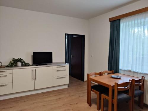 a living room with a table and a television at Neuhof in Neuhofen an der Ybbs