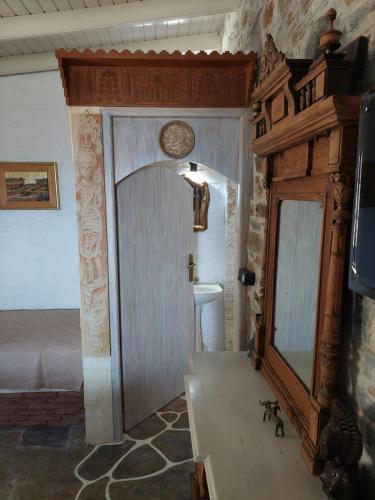 a bedroom with a mirror and a bed in a room at Villa Art Natalie two in Kithnos