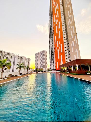 a swimming pool in a city with tall buildings at Meritus Residensi Penang in Perai