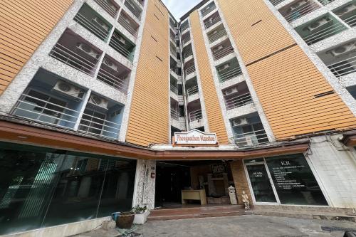 two tall buildings with windows and a restaurant at Phongsathon Mansion in Bangkok
