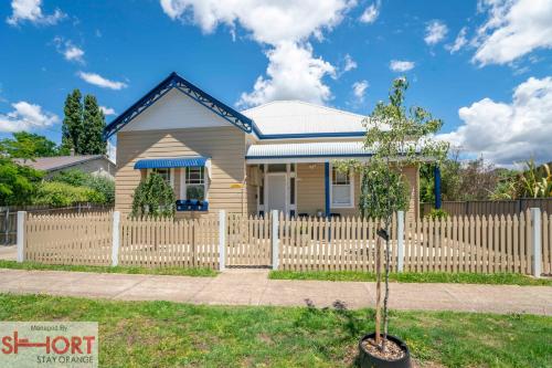 una piccola casa con una staccionata bianca di Paddington Villa 1 - Free Wi-fi, Netflix a Orange