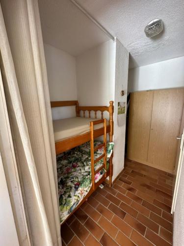 Cette petite chambre comprend des lits superposés. dans l'établissement Studio petit jardin, piscine, à Cogolin