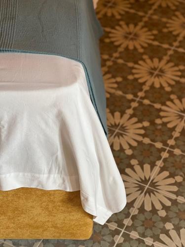 a close up of a bed with a white sheet at GarganoMareBorghi ospitalità diffusa in Vico del Gargano