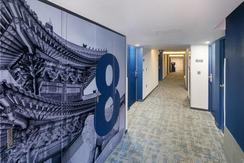 a hallway with a wall with a sign on it at Travelodge Myeongdong Namsan in Seoul