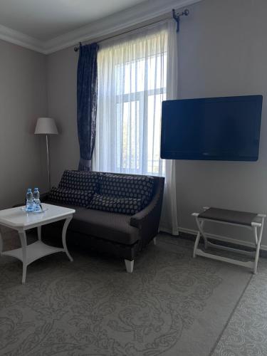 a living room with a couch and a large window at Palace Del Mar in Odesa