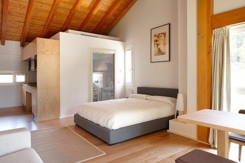 a bedroom with a bed and a table at Ureta Landa Gaztelugatxe in Bakio