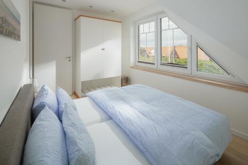 Ένα ή περισσότερα κρεβάτια σε δωμάτιο στο Haus Dünenkate Sandbank12