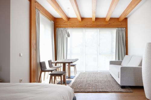 a bedroom with a bed and a couch and a table at Ureta Landa Gaztelugatxe in Bakio