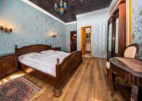 a bedroom with a bed in a room with blue walls at ZiRa Residence Brasov in Braşov
