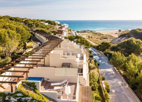 an aerial view of a building with the beach in the background at VIVA Cala Mesquida Suites & Spa Adults Only 16 in Cala Mesquida