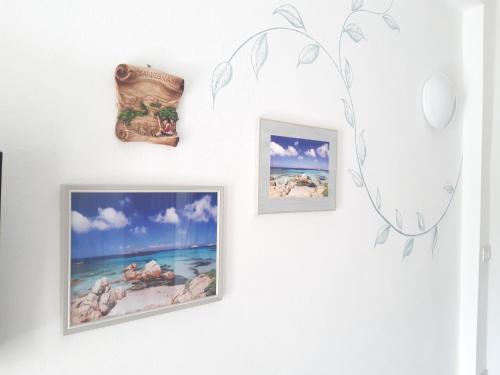 a group of pictures on a wall at Bellagio in Castelsardo