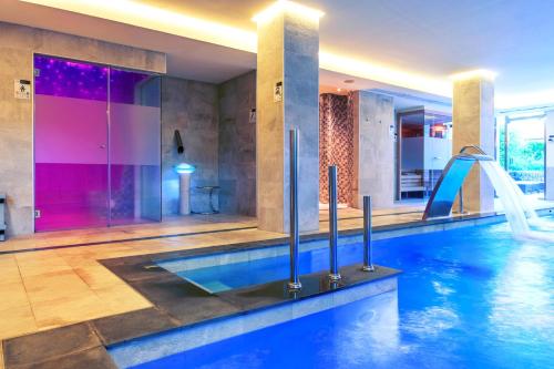 a pool with a water slide in a house at VIVA Blue & Spa in Playa de Muro