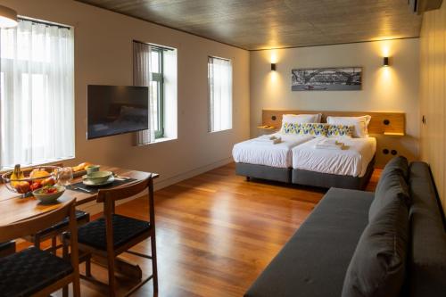 Ένα ή περισσότερα κρεβάτια σε δωμάτιο στο Fervença Suites