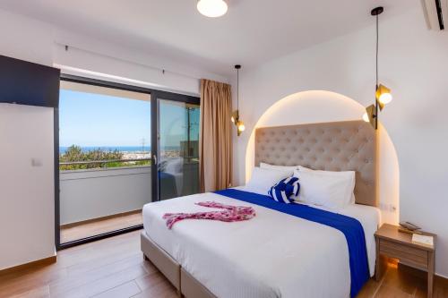 a bedroom with a large bed and a balcony at Villa Annalena by Villa Plus in Malia